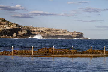 Fototapeta na wymiar Sea pool frozen surf splash, harbour, fence