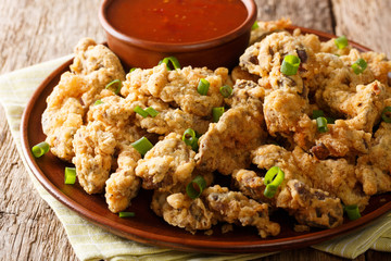 crispy fried chicken gizzards with a deep, rich, meaty flavor that are sliced in twisted bits and fried to perfection close-up on a plate. horizontal