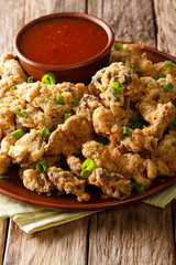 Southern Fried Chicken Gizzard are marinated in a spicy bath of buttermilk and hot sauce and are battered in a seasoned flour and fried. close-up on a plate. vertical