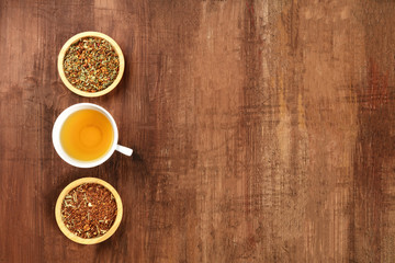 An overhead photo of tea, on a dark rustic background with copy space