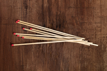 A handful of matches on a dark rustic background with copy space