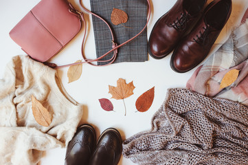 set of seasonal autumn fashion woman clothes, top view with copy space. Trendy shoes, sweater and...