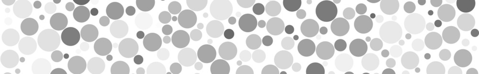 Abstract horizontal banner of circles of different sizes in shades of gray colors on white background