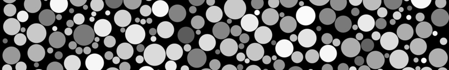 Abstract horizontal banner of circles of different sizes in shades of gray colors on black background
