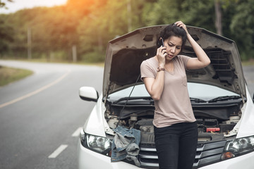 Young woman with broken car calling for help.Vintage color