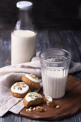Christmas gingerbread with nuts and seeds with milk on a wooden table. Delicious homemade treat for children and Santa Claus