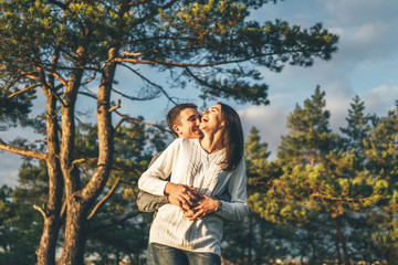 Fototapeta premium Pretty young couple walking together in the forest.