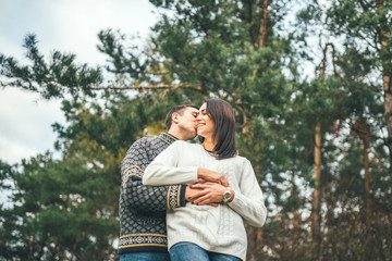 Fototapeta premium Pretty young couple walking together in the forest.