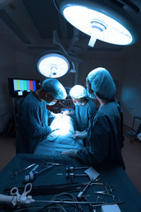 group of veterinarian surgery in operation room take with art lighting and blue filter