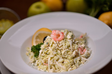 salad with shrimps and cabbage on a white plate