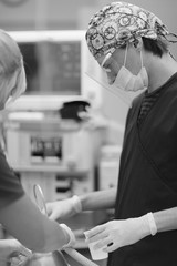 Assistant doctor in uniform in the operating room on the background of medical equipment