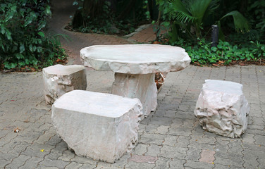 White marble stone bench set in the garden.