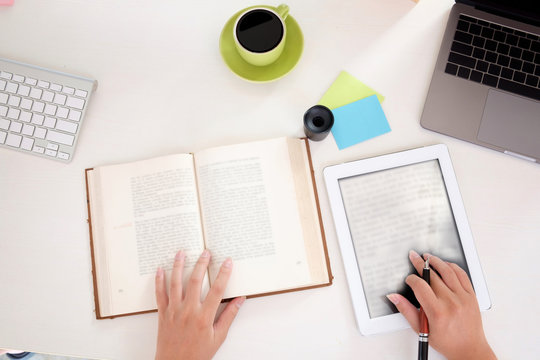 Top View E-book with a book on workplace ,Learning Education Electronics Technology Concept