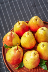 organic pears laying down on a lightly dotted kitchen cloth