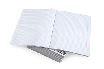 Open exercise book on a stack of other exercise books