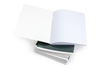 Open exercise book on a stack of other exercise books
