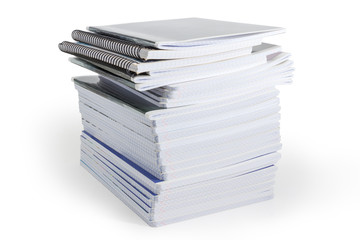 Big stack of the different exercise books on white background