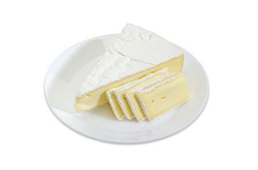 Partly sliced brie cheese on white dish