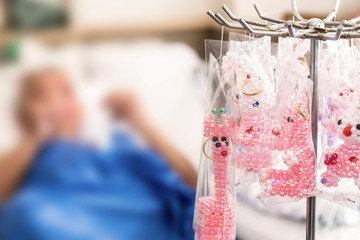 Disabled Old Man Patients iNfected with Bed Making Beads Keychain on the Bed in the Hospital.