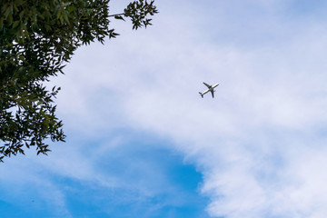 An airplane flying in the cloudy sky