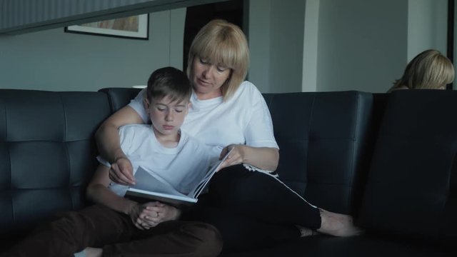 Mom helps my son do homework in the living room. The concept of a happy family