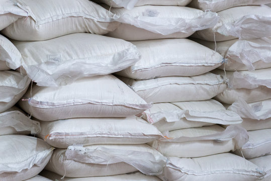 Stack of sugar or flour bags in warehouse
