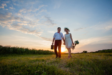 Naklejka na ściany i meble Rustic wedding couple at sunset in the summer outdoors