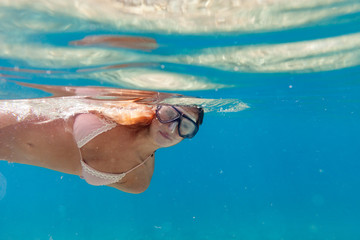 Woman snorkeling in the clear sea water