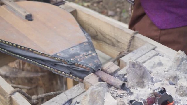 Smith forges nails