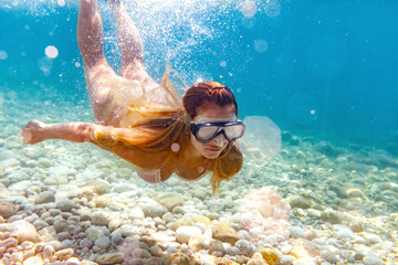 Woman snorkeling in the clear sea water