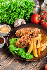 Crispy fried kentucky chicken legs with french fries