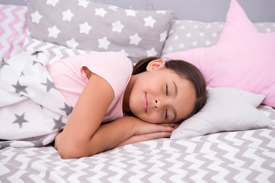 Girl child fall asleep on pillow. Quality of sleep depends on many factors. Choose proper pillow to sleep well. Girl lay on pillow bedclothes background. Child having nap. Cute badclothes and pillows