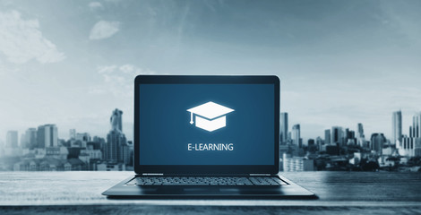 E-learning on computer laptop and city background. Online education, e-learning and e-book concept - obrazy, fototapety, plakaty