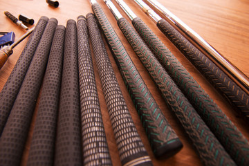 Golf club maintenance, changing old grips on an golf club. Shallow depth of field.