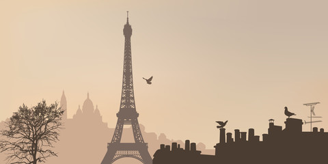 Naklejka premium Widok na Paryż z Wieżą Eiffla i Butte de Montmartre z Sacré-Coeur w mglisty dzień.