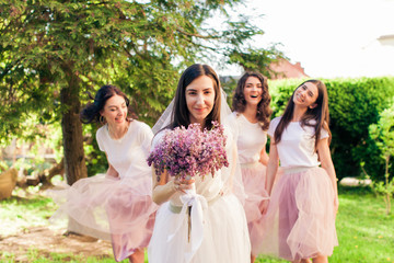 Celebration with bridesmaids in the green park