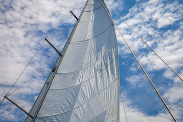 Fototapeta na wymiar Sailing a beautiful day. Yachting and relaxing on a beautiful boat. Blue Sky and wind.