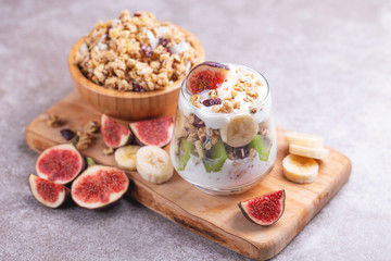 Granola with yogurt, bananas and figs. Copy space