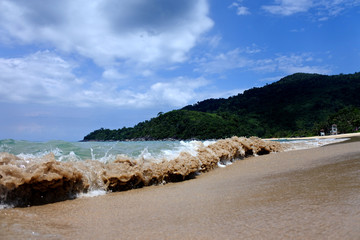 Fototapeta na wymiar Small beach waves close up on the Tiomen Island of Malaysia