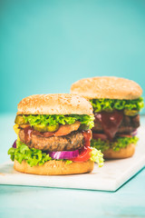 Homemade hamburgers on blue background