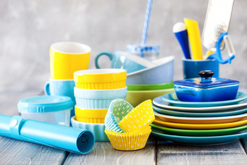 Colorful dishes and utensils. Ceramic kitchenware on a wooden background. Selective focus