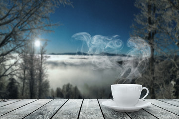 a hot coffee on the table on a winter background