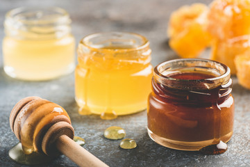 Selection of honey in small honey jars. Closeup view, toned image