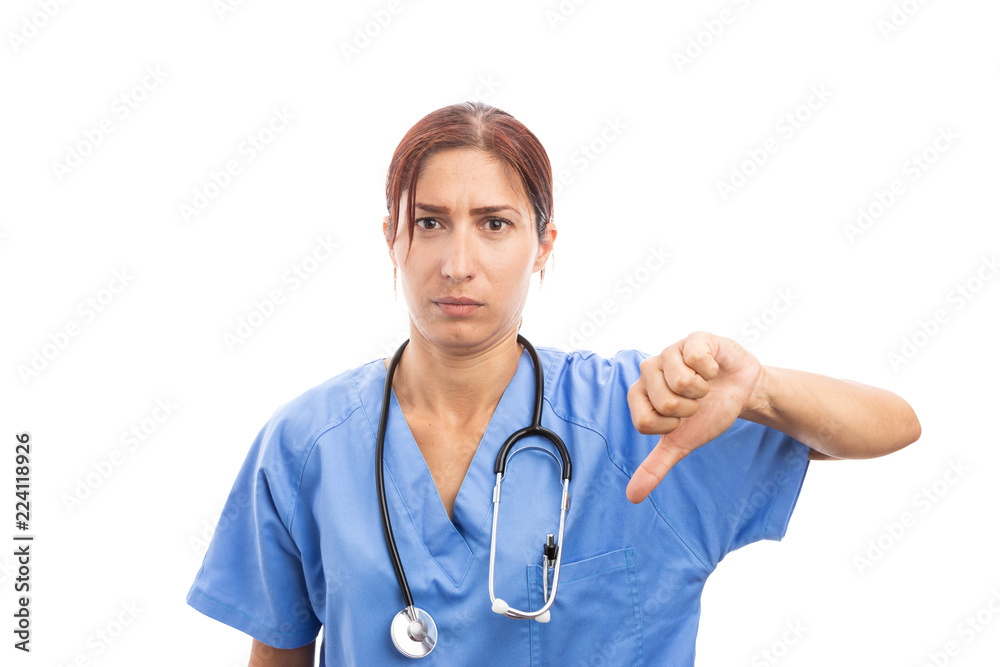 Wall mural upset female woman nurse or doctor making thumbs down gesture .