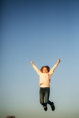 Little girl jump and have fun. Teen model in autumn