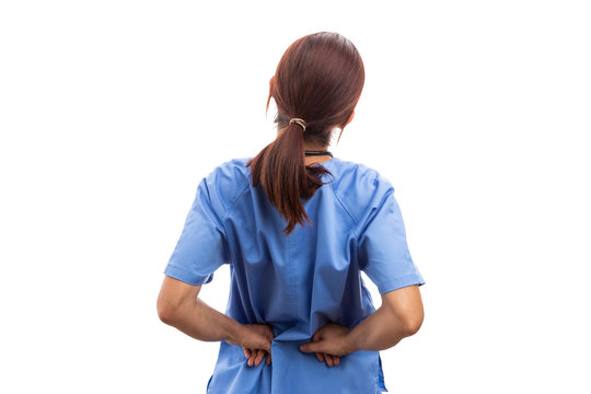 Rear view of female nurse or doctor holding painful lumbar area.