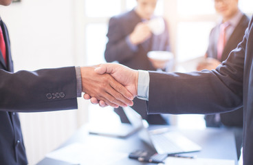 The agreement between business groups businessman shaking hands concept .
