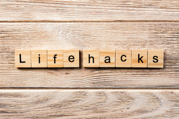 life hacks word written on wood block. life hacks text on table, concept © sosiukin