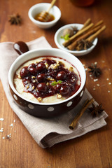 Oatmeal porridge with cherry sauce and spices