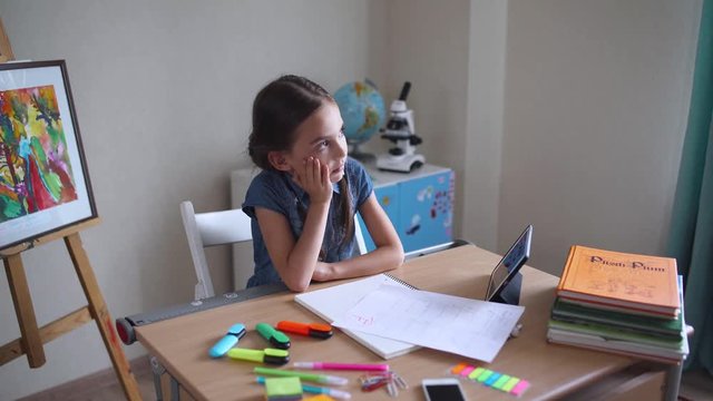 Schoolgirl in classroom, got a bad grade on test work, sad emotion.